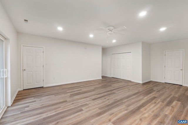 empty room with visible vents, baseboards, ceiling fan, light wood-style floors, and recessed lighting