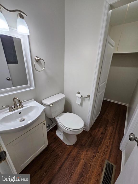 5507 Peters Ln, Fredericksburg, VA 22407 - half bathroom with wood finished floors, toilet, and vanity