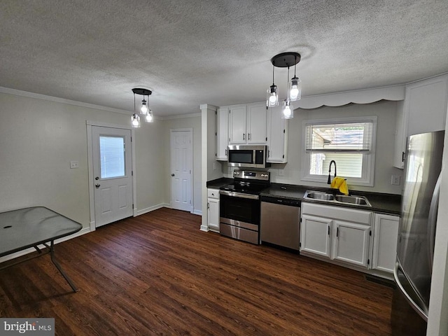 5507 Peters Ln, Fredericksburg, VA 22407 - kitchen with appliances with stainless steel finishes, a sink, dark countertops, dark wood-style floors, and white cabinets