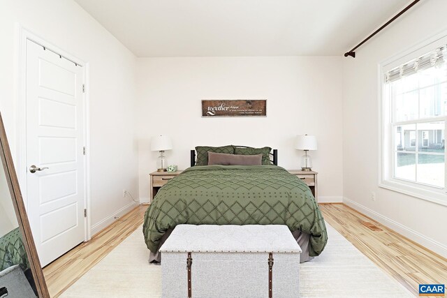 bedroom with light wood-style floors and baseboards