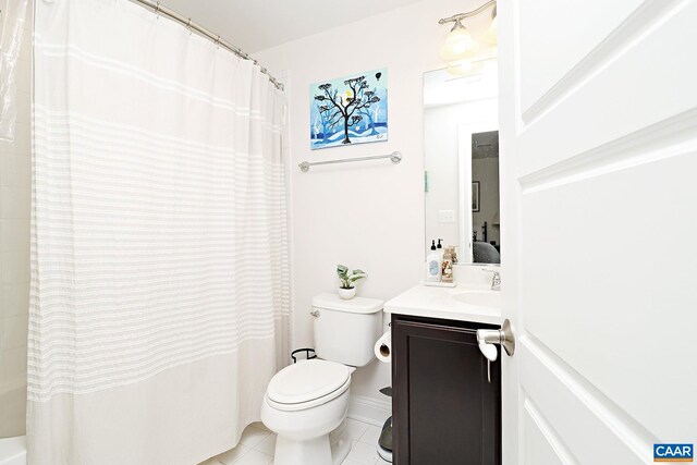 ensuite bathroom with vanity, toilet, connected bathroom, and tile patterned floors
