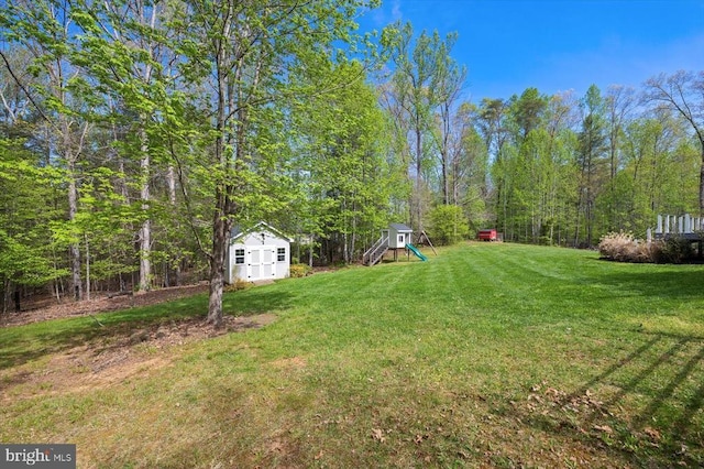 279 Carriage Ln, Madison, VA 22727 - view of green lawn with a playground, an outbuilding, and a storage shed