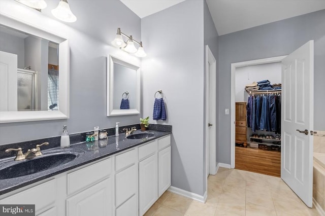 279 Carriage Ln, Madison, VA 22727 - full bathroom featuring a shower stall, double vanity, tile patterned flooring, a spacious closet, and baseboards