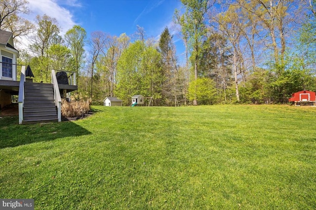 279 Carriage Ln, Madison, VA 22727 - view of green lawn with stairway, a shed, an outbuilding, and a deck