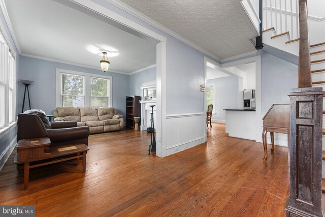 104 Fifth, Mineral, VA 23117 - living area with hardwood / wood-style flooring, wainscoting, ornamental molding, and stairway