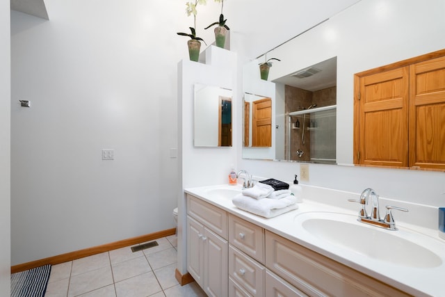 bathroom with walk in shower, tile patterned floors, toilet, and vanity