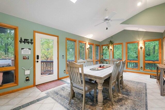 tiled dining space with ceiling fan and lofted ceiling