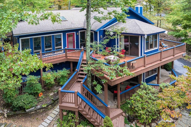 back of house with a wooden deck