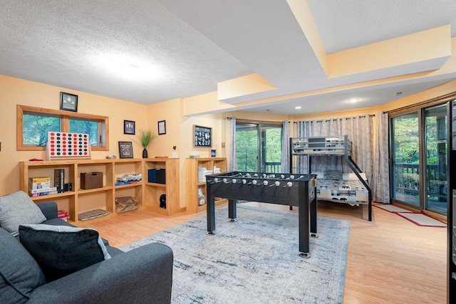 rec room with hardwood / wood-style flooring and a textured ceiling