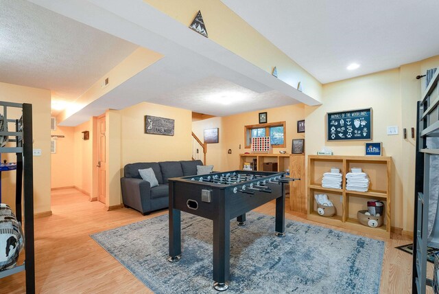 recreation room with hardwood / wood-style flooring