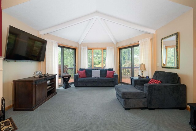 carpeted living room featuring lofted ceiling with beams and a healthy amount of sunlight