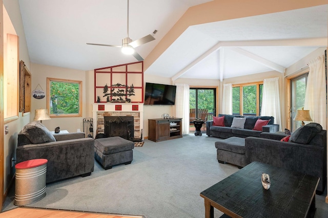 living room with ceiling fan, lofted ceiling, carpet, and a fireplace