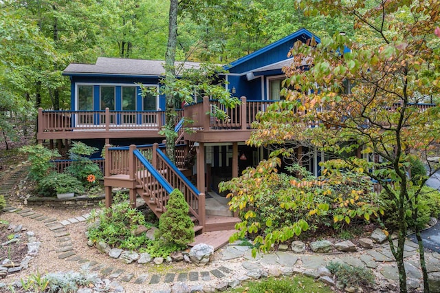 rear view of property featuring a deck