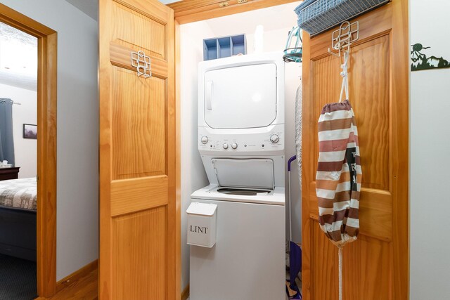 laundry area with stacked washing maching and dryer