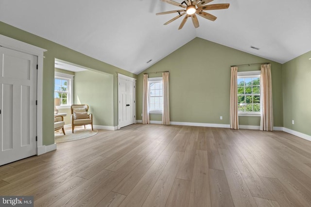 7345 Iron Bit Dr, Warrenton, VA 20186 - unfurnished living room with a ceiling fan, light wood-style floors, plenty of natural light, vaulted ceiling, and baseboards