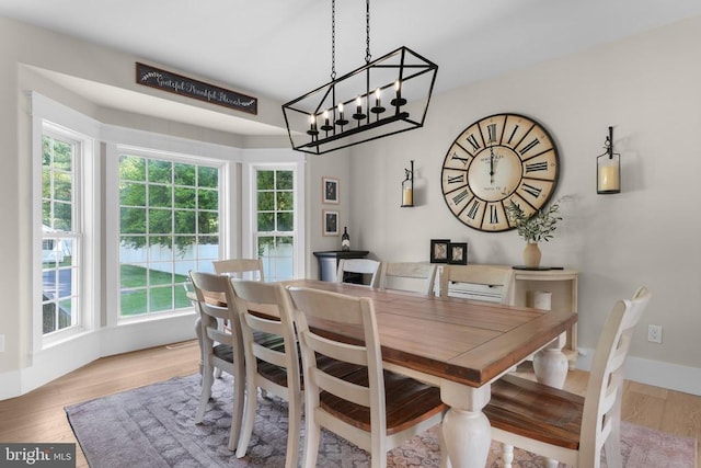 7345 Iron Bit Dr, Warrenton, VA 20186 - dining space with wood finished floors and a chandelier