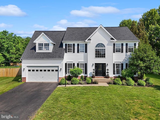 7345 Iron Bit Dr, Warrenton, VA 20186 - colonial house featuring asphalt driveway, an attached garage, and a shingled roof