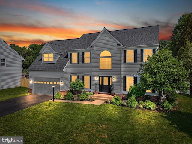 7345 Iron Bit Dr, Warrenton, VA 20186 - view of front of property featuring asphalt driveway, a shingled roof, a lawn, and an attached garage