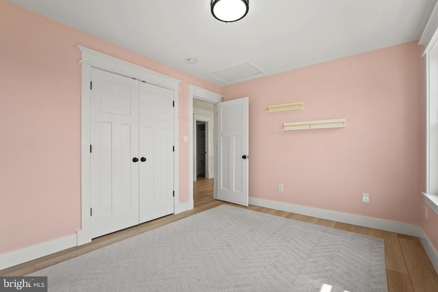 7345 Iron Bit Dr, Warrenton, VA 20186 - unfurnished bedroom featuring wood finished floors, baseboards, attic access, and a closet