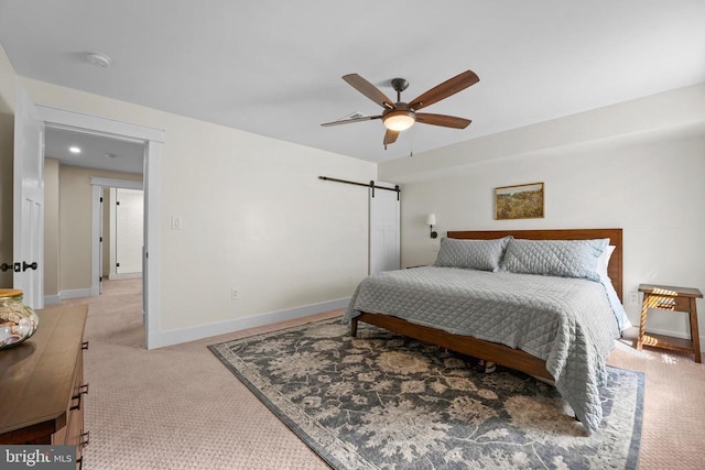 7345 Iron Bit Dr, Warrenton, VA 20186 - bedroom with light colored carpet, a barn door, baseboards, and a ceiling fan