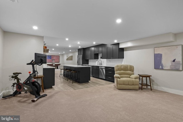 7345 Iron Bit Dr, Warrenton, VA 20186 - living room featuring bar with sink, baseboards, recessed lighting, and light carpet
