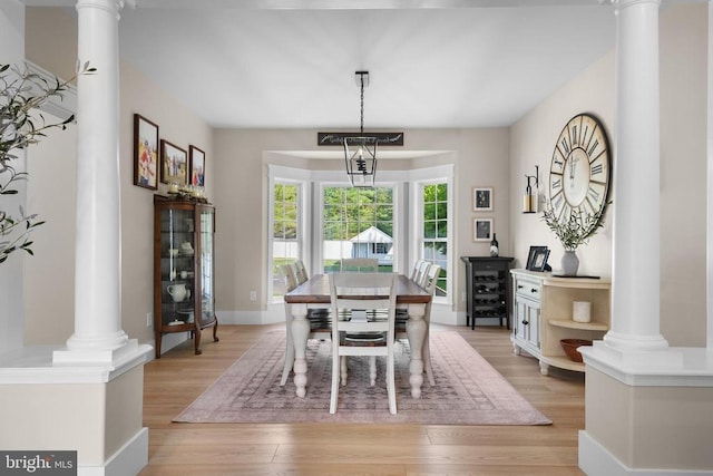 7345 Iron Bit Dr, Warrenton, VA 20186 - dining room with decorative columns and light wood-type flooring