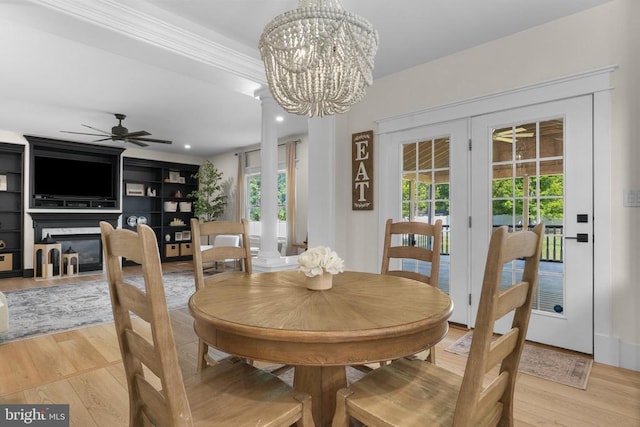 7345 Iron Bit Dr, Warrenton, VA 20186 - dining room with ceiling fan, light wood finished floors, french doors, a chandelier, and crown molding