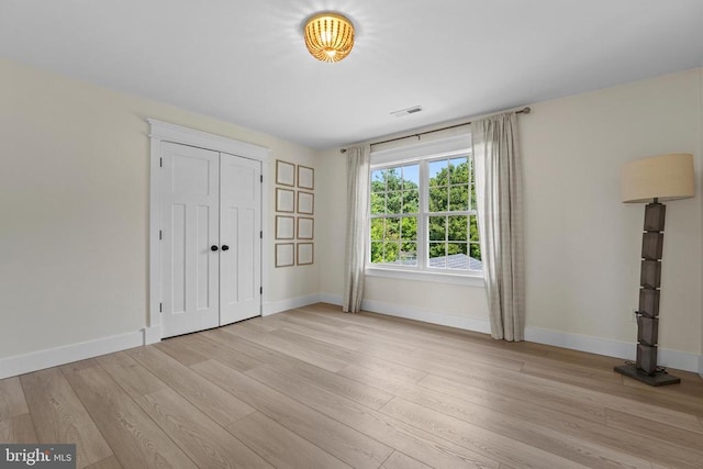 7345 Iron Bit Dr, Warrenton, VA 20186 - unfurnished bedroom featuring baseboards, light wood-style floors, and a closet