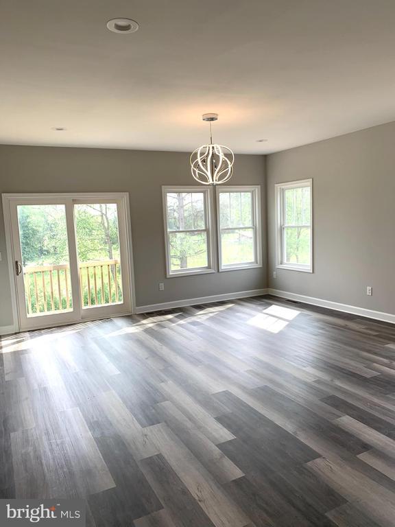 15477 Norman Rd, Culpeper, VA 22701 - unfurnished room featuring a chandelier and dark wood-style floors