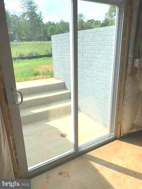 15477 Norman Rd, Culpeper, VA 22701 - doorway to outside featuring concrete floors