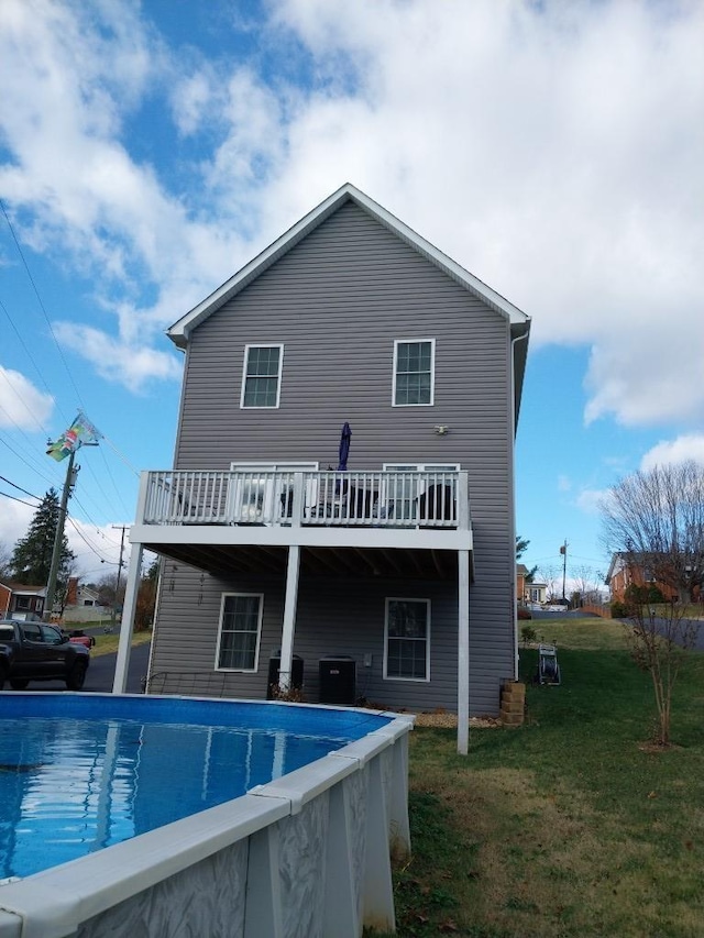 7 Rolla Mill Rd, Verona, VA 24482 - back of property featuring central air condition unit, a wooden deck, an outdoor pool, and a lawn