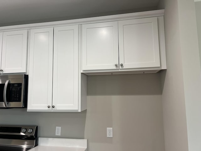 79 Meriwether Cir, Stuarts Draft, VA 24477 - kitchen view of stainless steel microwave, range, white cabinets, and light countertops