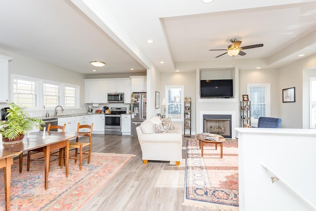 123 Beauregard Dr, Staunton, VA 24401 - living room with light wood-style floors, a fireplace, a ceiling fan, recessed lighting, and a tray ceiling