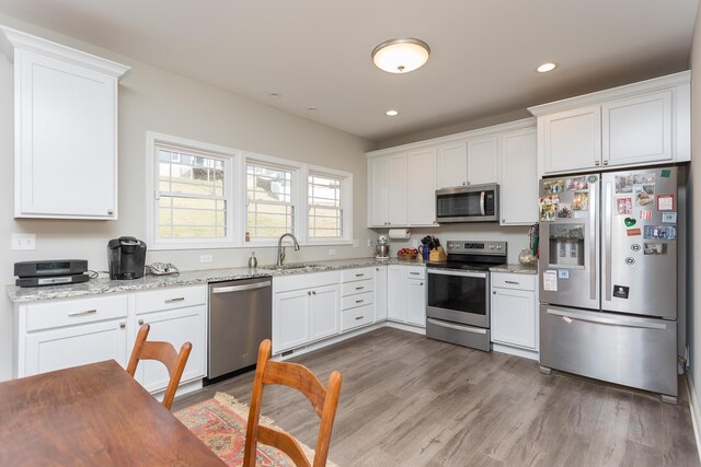 123 Beauregard Dr, Staunton, VA 24401 - kitchen featuring stainless steel appliances, white cabinets, wood finished floors, light stone countertops, and recessed lighting