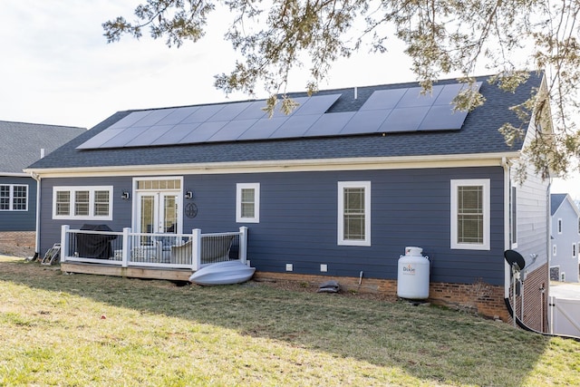 123 Beauregard Dr, Staunton, VA 24401 - back of property with a wooden deck, a yard, roof mounted solar panels, and a shingled roof
