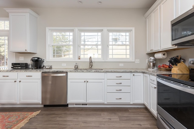 123 Beauregard Dr, Staunton, VA 24401 - kitchen featuring appliances with stainless steel finishes, white cabinetry, wood finished floors, light stone countertops, and recessed lighting