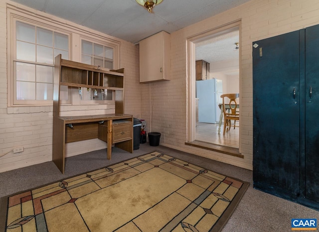 interior space featuring brick wall