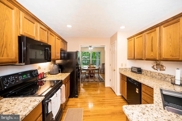 106 Tallwood Trl, Locust Grove, VA 22508 - kitchen with black appliances, brown cabinets, tasteful backsplash, light wood finished floors, and recessed lighting