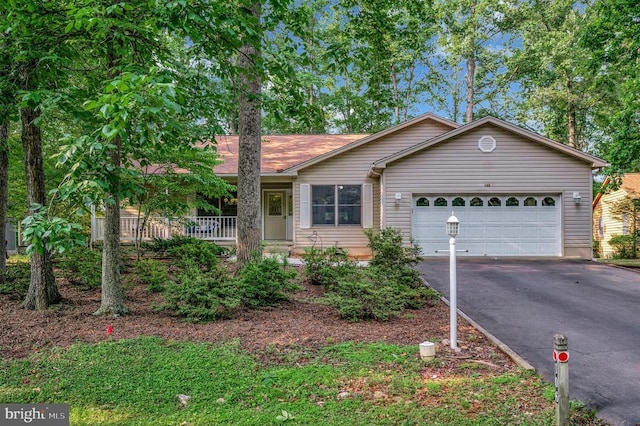 106 Tallwood Trl, Locust Grove, VA 22508 - single story home with asphalt driveway, a garage, and covered porch
