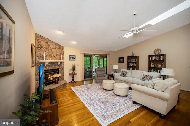 106 Tallwood Trl, Locust Grove, VA 22508 - living room featuring lofted ceiling, wood finished floors, a stone fireplace, and ceiling fan