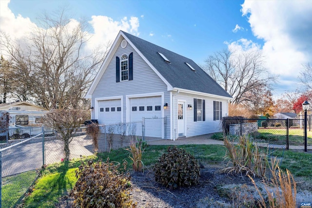 view of property exterior with a shingled roof, fence, and a detached garage