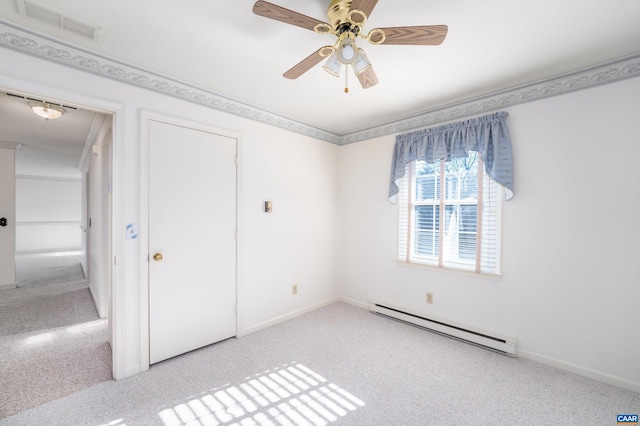 unfurnished bedroom with a baseboard heating unit, carpet flooring, visible vents, and a ceiling fan