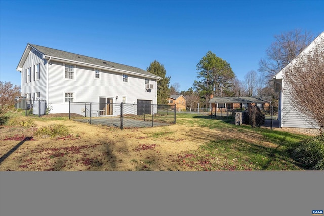 rear view of house featuring cooling unit, a lawn, and a fenced backyard