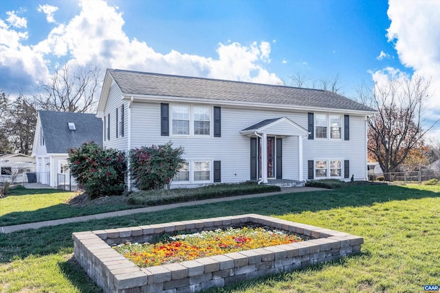 split foyer home with fence and a front lawn