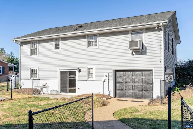 back of house with a yard, an attached garage, fence, and an AC wall unit
