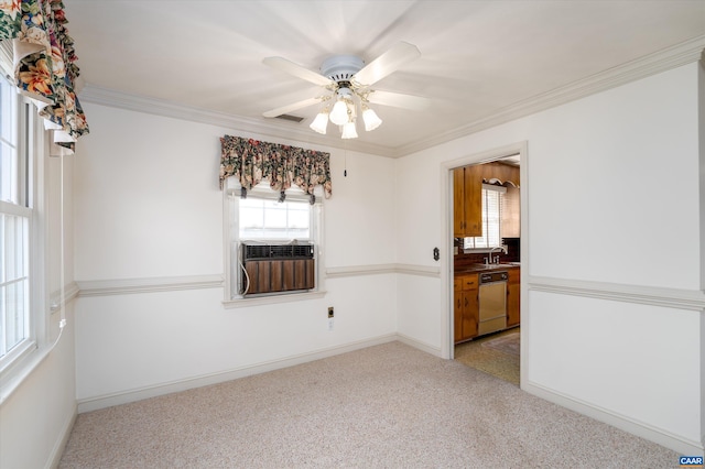 unfurnished room featuring a sink, visible vents, ceiling fan, light colored carpet, and ornamental molding