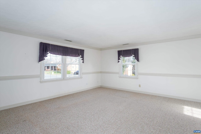unfurnished room with crown molding, visible vents, baseboards, and carpet