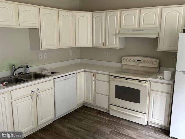 4020 Englandtown Rd, Fredericksburg, VA 22408 - kitchen with white appliances, under cabinet range hood, dark wood-style flooring, light countertops, and white cabinets