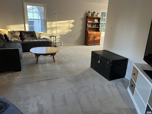 living area with carpet flooring, baseboards, and a baseboard heating unit