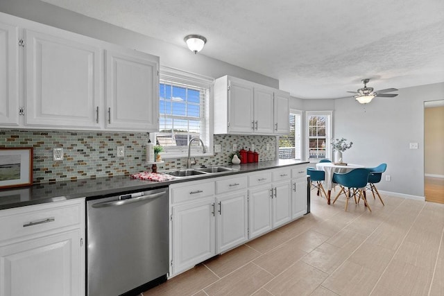 38 Boyington Blvd, Waynesboro, VA 22980 - kitchen featuring stainless steel dishwasher, backsplash, dark countertops, a textured ceiling, and white cabinetry
